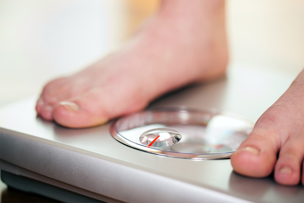 Woman stepping on the scales
