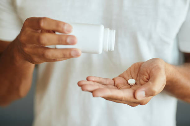 Close-up of unrecognizable man taking modafinil